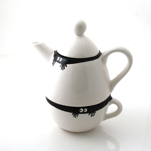 Teapot and cup with peeping monster eyes