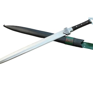 May include: A silver sword with a black and silver handle and a black scabbard. The sword has a straight, double-edged blade and a decorative hilt. The scabbard is black with a green strap.