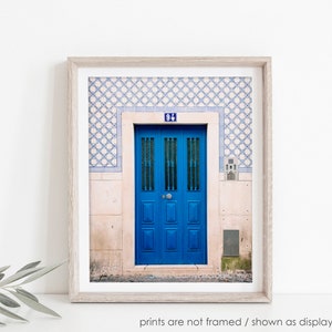 May include: A blue door with a white frame and a blue tile pattern above it. The door has a number "94" on it.