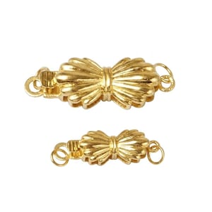 May include: Two gold-colored bow-shaped clasps. The clasps have a textured, ridged design and are connected with a small loop on each end. The clasps are likely for jewelry or other accessories.