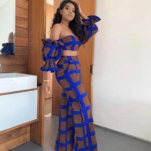 Puede incluir: Un conjunto de dos piezas con estampado azul y naranja, con un top corto y pantalones anchos.