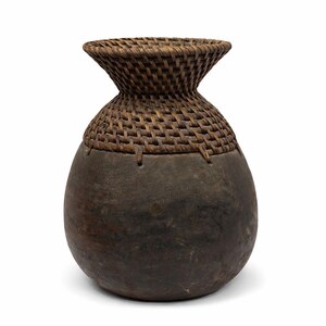 May include: A handcrafted, dark brown decorative vase with a woven, basket-like top and a rounded, gourd-shaped body. The top is a lighter brown, contrasting with the darker, smooth body. The vase has a rustic, natural aesthetic.