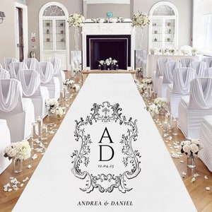 May include: White aisle runner with a black and white monogram design featuring the letters "A" and "D" with the date "12.04.25" and the text "ANDREA & DANIEL".