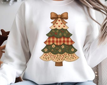 Può includere: Felpa bianca con un design a forma di albero di Natale. L'albero è composto da strati rossi, verdi e beige, adornati con cuori, fiori e un fiocco. Il design è centrato sulla parte anteriore della felpa.