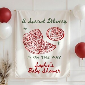May include: A cream-colored banner with red and green text and illustrations. The banner reads "A Special Delivery is on the Way Sophie's Baby Shower" with a pizza graphic. Red and white balloons are on either side.
