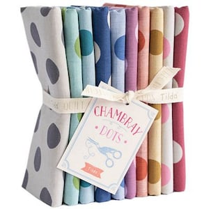 May include: A bundle of 10 fabric squares featuring a Chambray Dots design by Tilda. The fabric squares are in various shades of blue, green, pink, and yellow with white polka dots.
