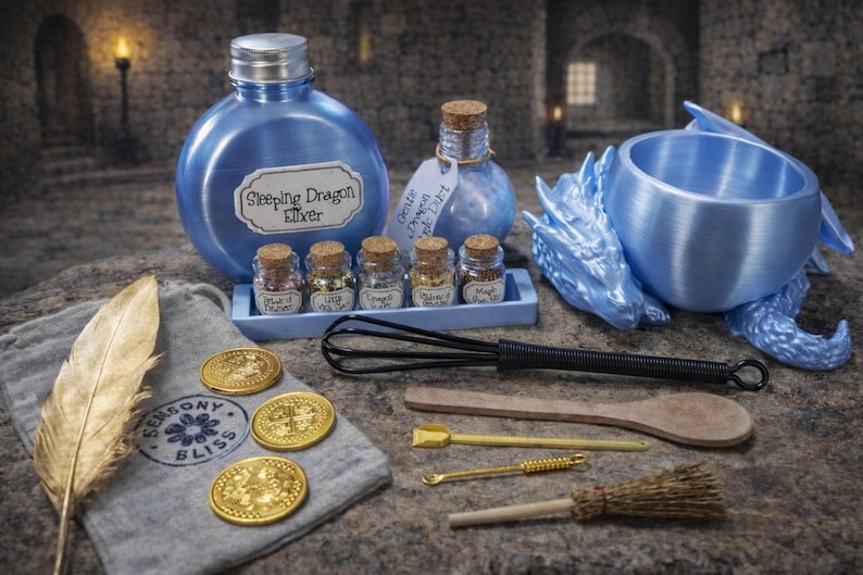 A blue-themed dragon potion kit displayed on stone, featuring a large round elixir bottle, a blue dragon cauldron, five tiny ingredient bottles, and assorted toy spellcasting tools.