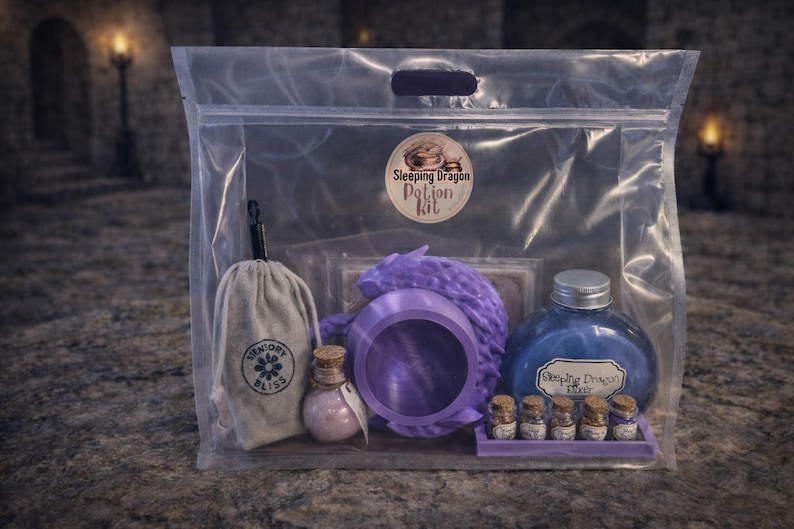 A clear plastic zipper bag containing a purple sleeping dragon potion kit with a cauldron, bottled elixir, and mini jars sitting on a stone surface.