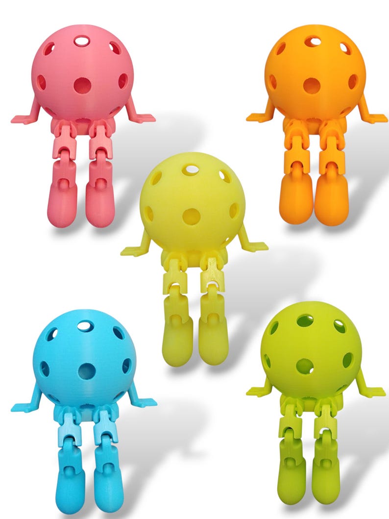 May include: Five colorful, articulated ball-shaped figures with jointed legs and small arms. The figures are in shades of pink, orange, yellow, blue, and green. Each figure has a spherical head with several circular holes.