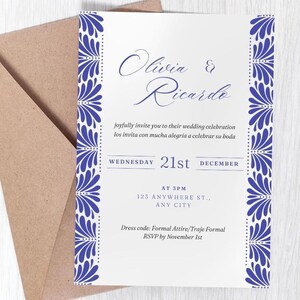 May include: A wedding invitation with a white background and blue floral border. The invitation includes the names "Olivia & Ricardo" in elegant script, along with the date, time, and location of the wedding. The dress code is formal attire.
