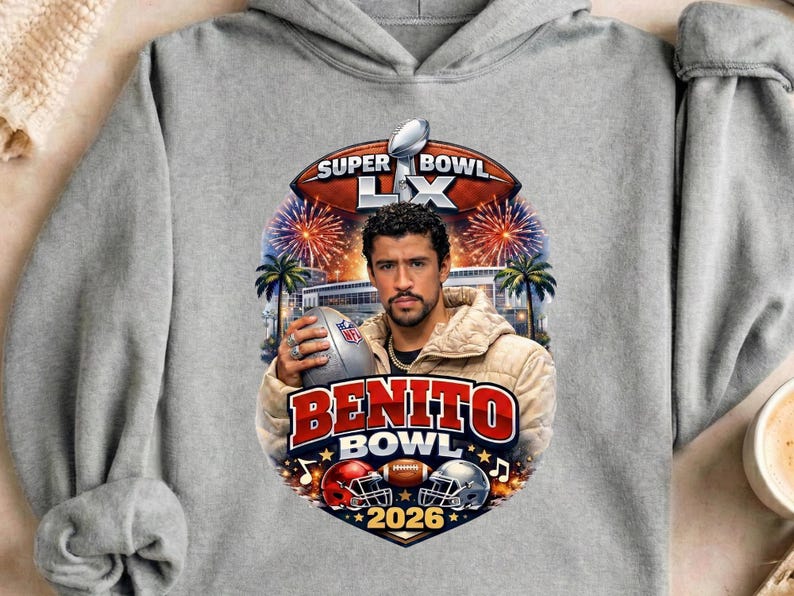 May include: A gray hoodie featuring a graphic with the text "Super Bowl LX" and "Benito Bowl 2026". The graphic includes a football, fireworks, palm trees, and a portrait of a man holding a football.