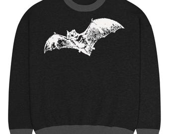 May include: Black sweatshirt with a white bat graphic. The sweatshirt has a dark gray crew neck, cuffs, and hem. The bat graphic is a detailed illustration of a bat in flight.