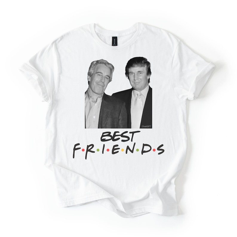 May include: White t-shirt with a black and white image of two men. The text "BEST FRIENDS" is printed in a colourful font below the image. The shirt is made of a soft material.
