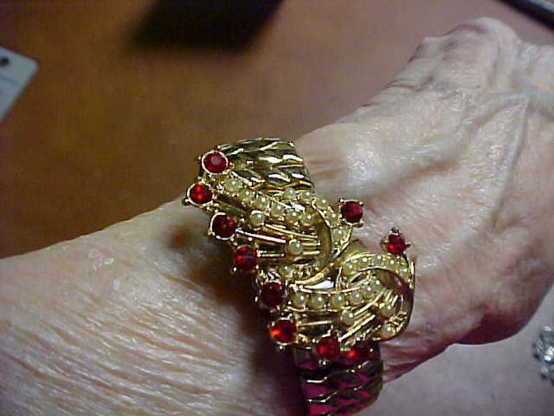 Expansion bracelet and matching brooch with red rhinestones and faux pearls