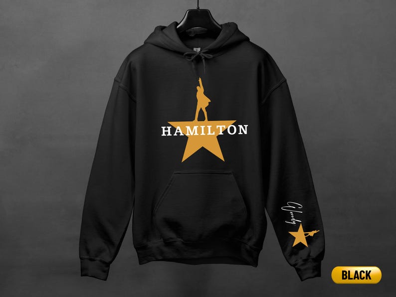 A black hoodie with a yellow star and the word "HAMILTON" printed on it.