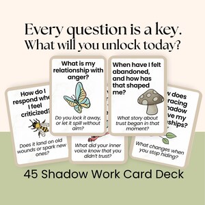 May include: A deck of 45 Shadow Work cards with various questions and illustrations. The cards feature a butterfly, mushroom, bee, and other images. Text on the cards includes questions about anger, abandonment, and self-reflection.