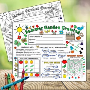 May include: Two colorful activity sheets titled "Summer Garden Growing" with illustrations of garden tools, vegetables, and insects. The sheets include fill-in-the-blank sections, a garden maze, and a drawing activity. Crayons are visible in the foreground.