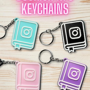 May include: A selection of Bookish NFC keychains in teal, black, pink, and purple. Each keychain has a book-shaped design with an Instagram logo, connected to a chain and keyring. The text "BOOKISH NFC KEYCHAINS" is displayed above.