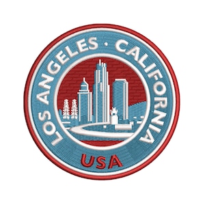 May include: Embroidered patch featuring a circular design with the text "LOS ANGELES CALIFORNIA" in white on a blue background. The center shows a skyline in white and blue, with the word "USA" in red at the bottom. The patch has a red border.