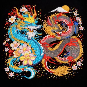 May include: Embroidered artwork featuring two dragons facing each other on a black background. One dragon is blue with yellow and red accents, surrounded by flowers. The other is gray with red and yellow details, with a sun and mountain in the background.