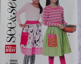 See & Sew B6611  Easy Sewing Pattern Girls' Aprons with Contrast Pockets  Size M, L, XL  (7 - 16) UNCUT