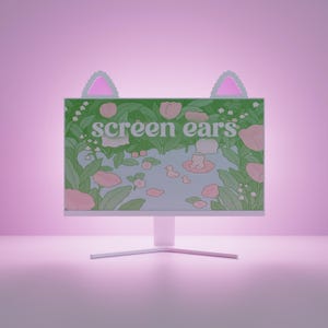 Peut inclure: Un écran d'ordinateur avec un support blanc et un écran affichant une scène d'étang avec des canards, des fleurs et le texte "screen ears". Des décorations en forme d'oreilles de chat en vert clair et rose sont fixées en haut de l'écran.