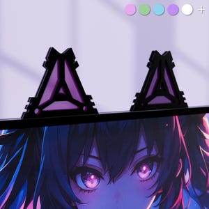 May include: Black and purple cat ear-shaped monitor accessories. The ears have a geometric design with a purple interior and are mounted on top of a computer monitor. The image also shows a close-up of an anime character's eyes.