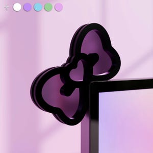 May include: A black computer monitor with a purple bow-shaped decoration on top. The bow is made of two overlapping hearts.