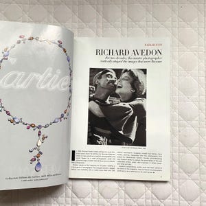 May include: A black and white photograph of a couple laughing. The man is wearing a dark shirt and the woman is wearing a white shirt. The text "BAZAAR ICON RICHARD AVEDON" is at the top of the image. The text "For two decades, this master photographer radically shaped the images that were Bazaar." is below the photograph.