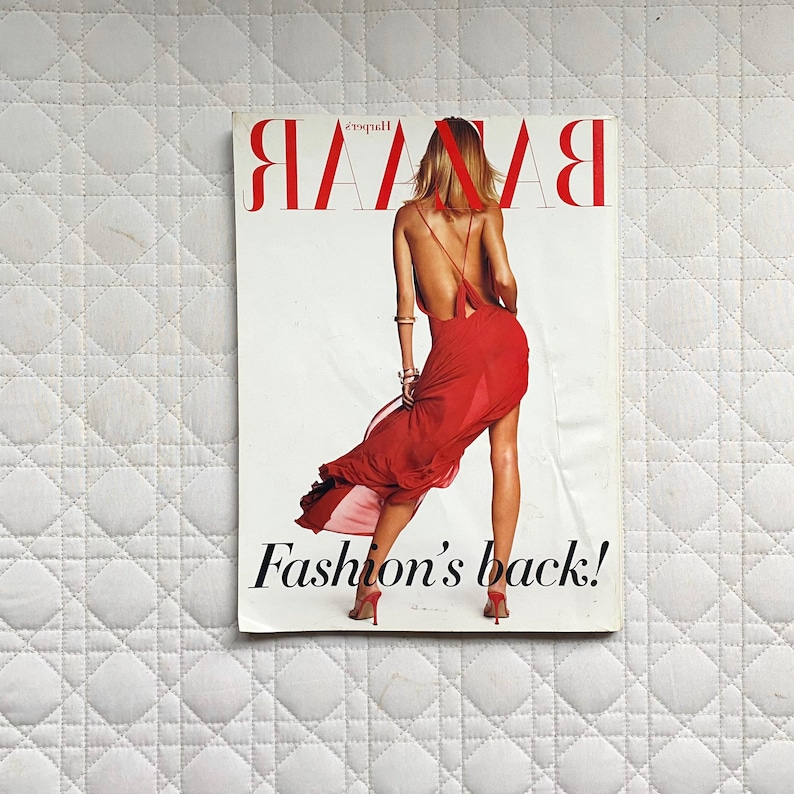 May include: A magazine cover featuring a woman in a red dress with the title "Harper's BAZAAR" and the text "Fashion's back!"