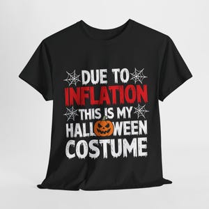 May include: Black t-shirt with white text that reads "Due to inflation this is my Halloween costume" with a cartoon pumpkin graphic.
