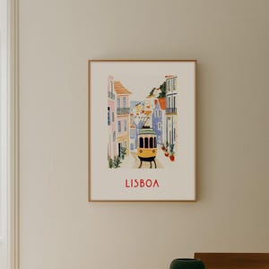 May include: A framed illustration of a yellow tram traveling through a narrow street in Lisbon, Portugal. The buildings are colorful and have tiled facades. The text "LISBOA" is printed in red at the bottom of the illustration.