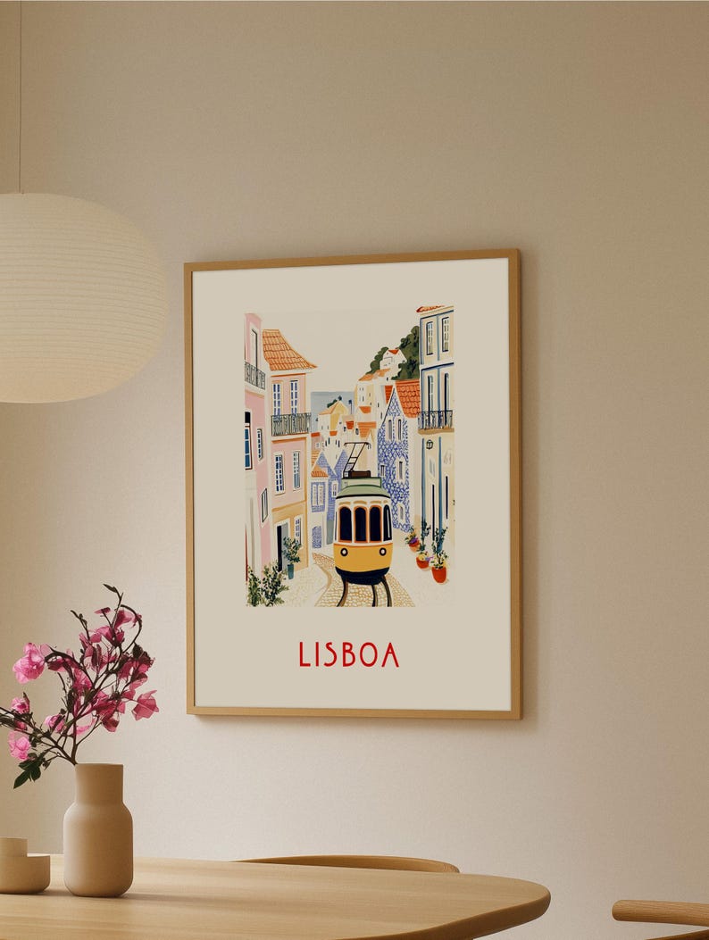 May include: A vintage-style illustration of a yellow tram traveling through a colorful street in Lisbon, Portugal. The buildings are painted in shades of pink, blue, and yellow, and the street is lined with potted plants. The text "LISBOA" is printed in red at the bottom of the image.