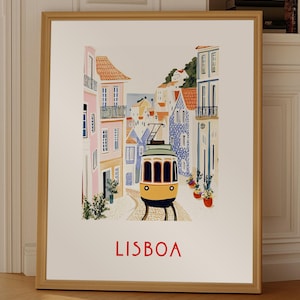 May include: A framed print of a colorful illustration of a yellow tram traveling through a street in Lisbon, Portugal. The buildings are painted in shades of pink, blue, and white. The text "LISBOA" is printed in red at the bottom of the print.