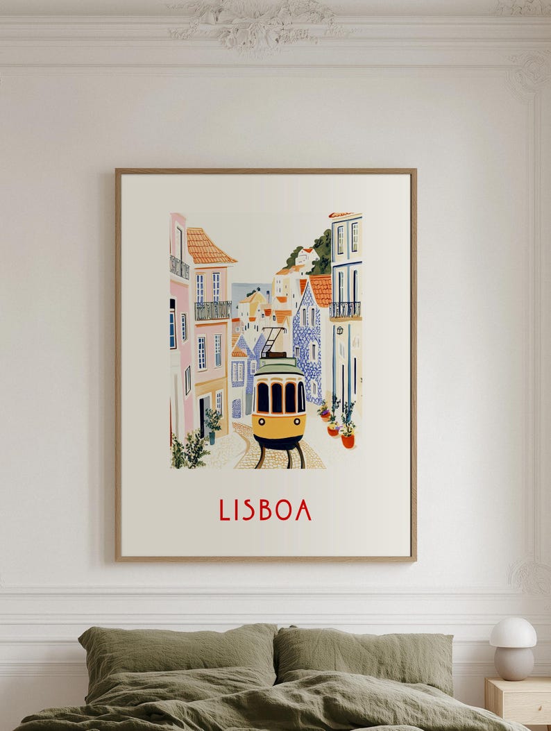 May include: A vintage-style illustration of a yellow tram traveling through a colorful, tiled street in Lisbon, Portugal. The text "LISBOA" is printed in red at the bottom of the image.