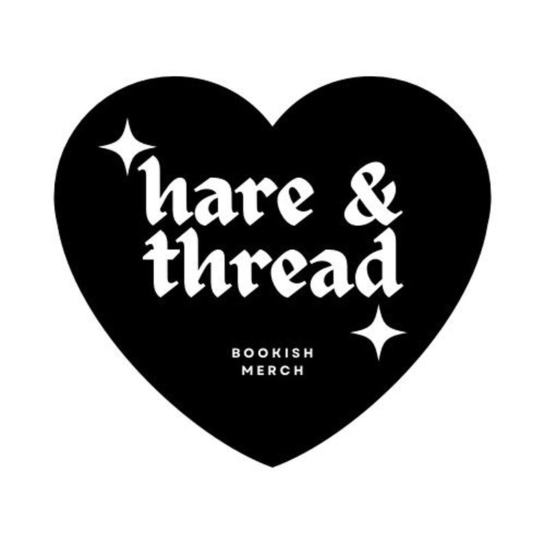 May include: A black heart-shaped logo with the words "hare & thread" in white gothic font. Below, the text "BOOKISH MERCH" is also in white. Two white starbursts accent the design.