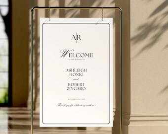 May include: A white welcome sign with gold lettering. The sign reads "AR Welcome to the wedding of Ashleigh Honig and Robert Zingaro September 21st, 2023 Thank you for celebrating with us!"