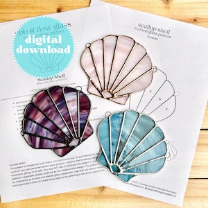 May include: A digital download pattern for a stained glass scallop shell suncatcher. The pattern includes 10 pieces and is available in a purple, blue, and pink color scheme. The pattern is labeled "Scallop Shell Suncatcher Pattern" and includes the text "ebb & flow glass" and "#ebbandflowglasspatterns".