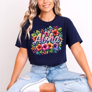 May include: A navy blue t-shirt with a colorful floral design and the word "Aloha" in a rainbow font.