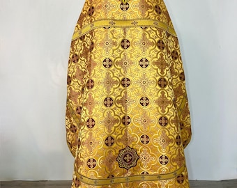 May include: A gold liturgical vestment with a cross pattern and red accents. The vestment has a white lining and gold fringe.