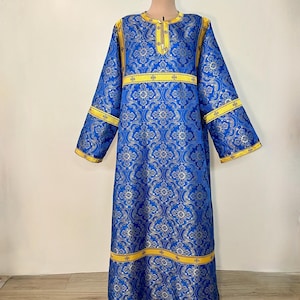 May include: A long, blue robe with a gold and yellow patterned design. The robe has a high neckline and long sleeves. It is trimmed with gold and yellow ribbon.