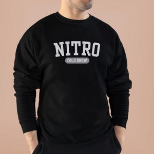 May include: Black sweatshirt with white text that reads "NITRO COLD BREW".