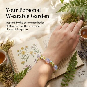 May include: A bracelet with light blue and white beads, and small yellow and green accents, is displayed on a wrist. The image includes text that reads "Your Personal Wearable Garden". The bracelet is set against a backdrop of a book, tea, and greenery.