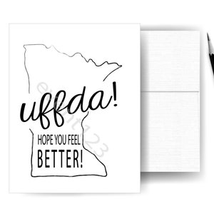 Peut inclure: Une carte blanche avec un contour noir de l'état du Minnesota. Le texte "uffda!" est écrit en grande police stylisée. En dessous du texte se trouve la phrase "Hope you feel better!"