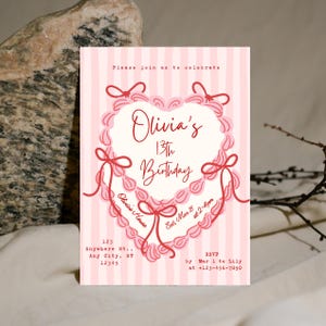 Puede incluir: Invitación de cumpleaños a rayas rosas y blancas con un diseño en forma de corazón. La invitación incluye el texto "Olivia's 13th Birthday" e información RSVP. El diseño presenta lazos decorativos y un borde similar a un pastel.