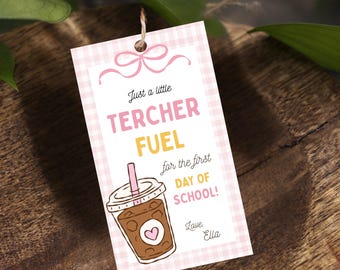 May include: A rectangular gift tag with a light pink gingham border, featuring a pink bow graphic at the top. The text reads: Just a little TERCHER FUEL for the first DAY OF SCHOOL! Love, Ella. Below is an illustration of an iced coffee cup.