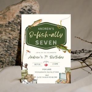 May include: A birthday invitation with a fishing theme. The invitation features the text "Andrew's 7th Birthday" and "O-fish-ally Seven" in a green and white design. Illustrations of fish, fishing gear, and the date are included.