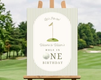 May include: A rectangular sign with a beige and white vertical striped border featuring a central oval containing a golf hole illustration, a golf ball, and the text Let's Par-tee! Welcome to William's HOLE IN ONE BIRTHDAY in dark green font.