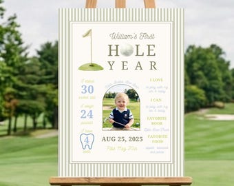 May include: A rectangular milestone sign with a beige and white striped border featuring golf-themed graphics, text reading William's First HOLE YEAR, a central photo of a child, and statistics including 30 inches tall, 24 pounds, and 4 teeth.
