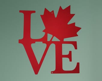 May include: Red metal wall art featuring the word "LOVE" with a maple leaf design in the center.